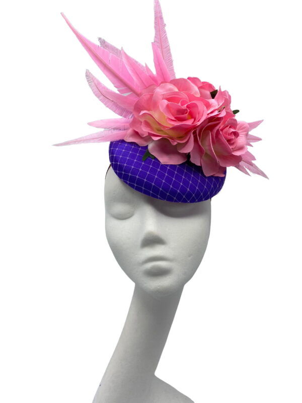 Stunning purple based headpiece with stunning candy pink flower and feather detail.